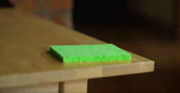 Green sponge on a table about to demonstrate the sponge effect
